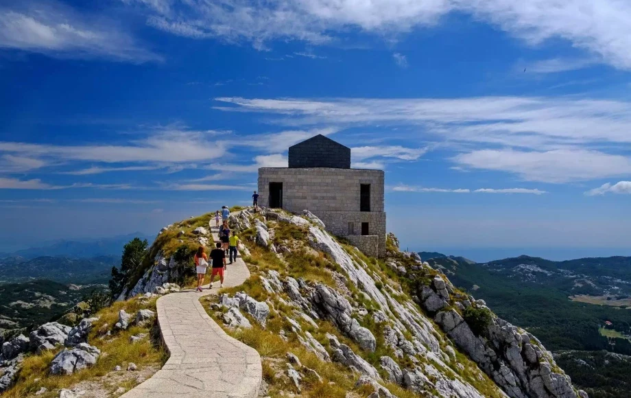 Lovćen Mausoleum at the peak of Lovćen National Park, Montenegro, with panoramic mountain views.
